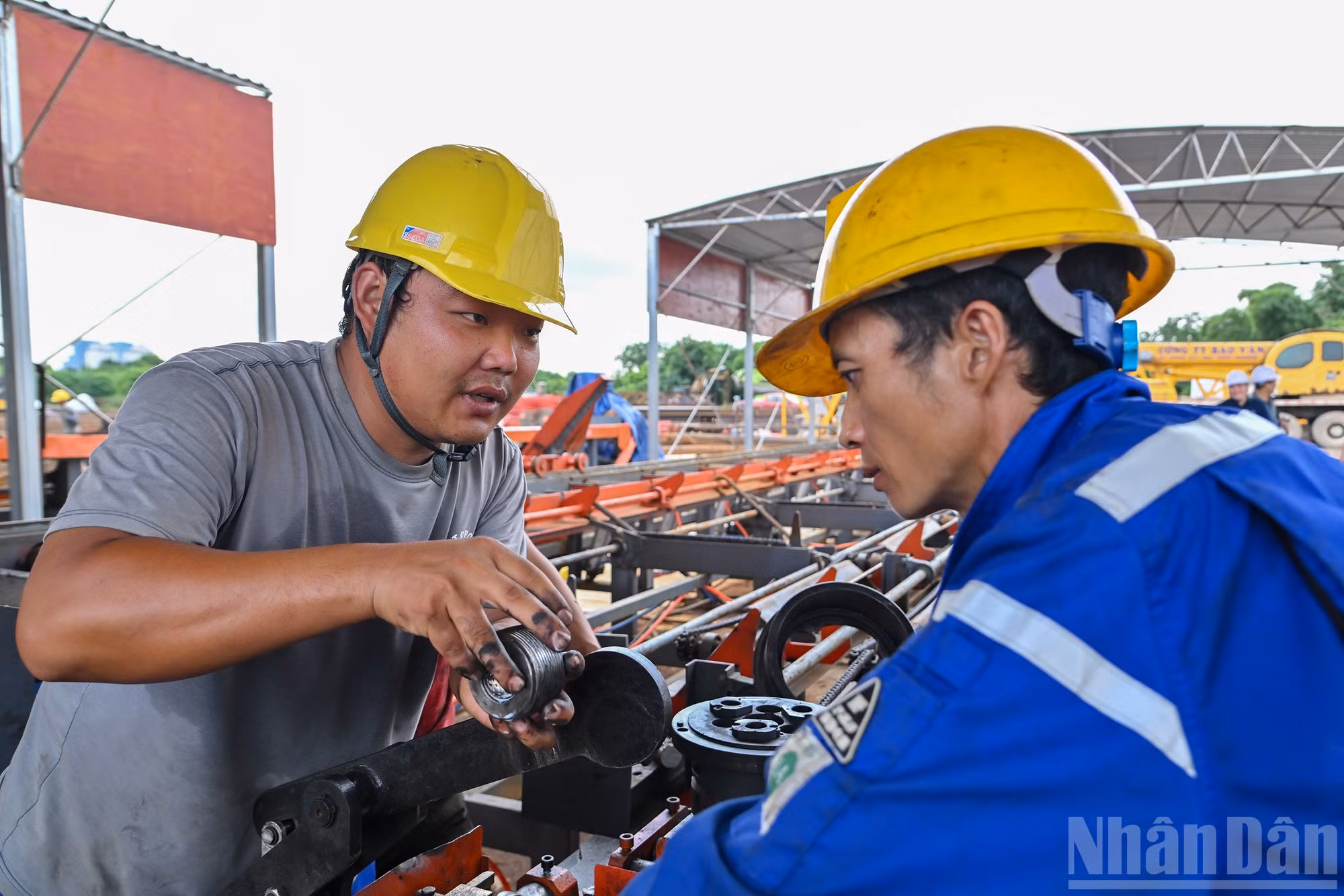 Các công nhân trao đổi về yếu tố kỹ thuật trên công trường.