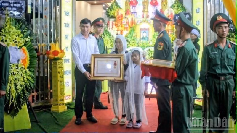Thừa ủy quyền của Chủ tịch nước, đồng chí Lê Huy, Phó Chủ tịch Thường trực Ủy ban nhân dân tỉnh Hưng Yên trao Quyết định truy tặng Huân chương Dũng cảm cho nhân thân Trung tá Trần Văn Tùng. (Ảnh: MAI TÚ)