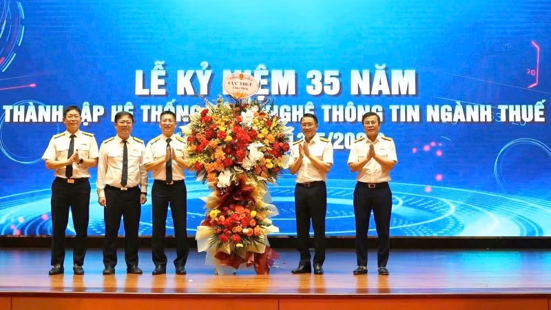 Phó Cục trưởng Mai Sơn và Phó Cục trưởng Lê Long tặng hoa chúc mừng.