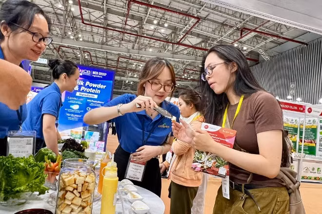 Khách tham quan sử dụng thử các mẫu thực phẩm, đồ uống tại ngày khai mạc.