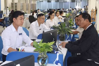 Cán bộ tại bộ phận một cửa Ủy ban nhân dân tỉnh Quảng Ngãi tiếp đón và giải quyết hồ sơ cho người dân. (Ảnh: HIỂN CỪ)